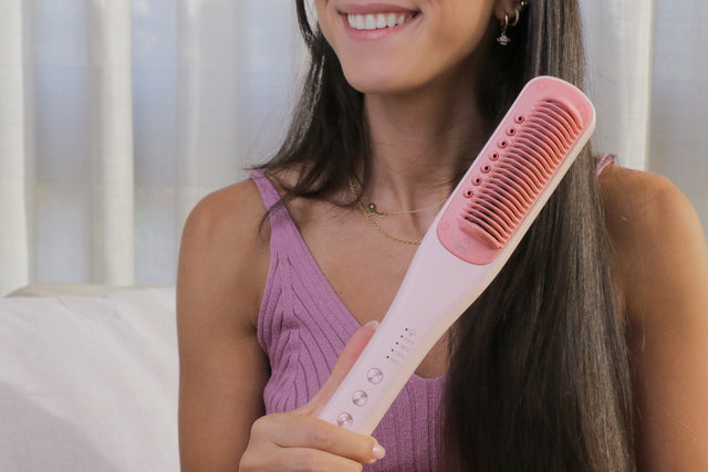 Woman holding the SteamPro with smooth long hair